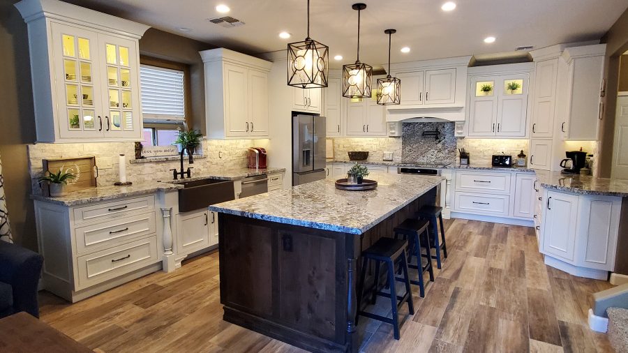 Modern kitchen design featuring white cabinetry, granite countertops, and pendant lighting, illustrating a stylish and functional space for home remodeling in Denver.