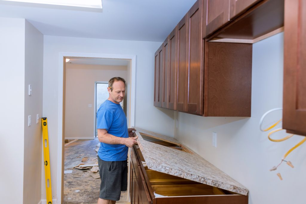 A professional kitchen contractor during an countertop installation